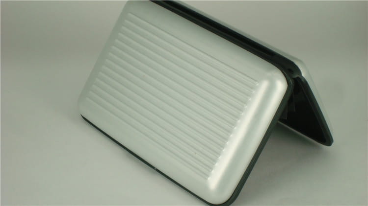silver metallic rfid blocking aluminum alloy ribbed card holder case with black trim shown from the back side