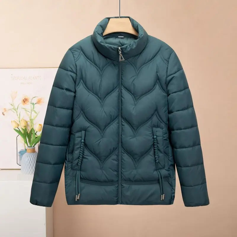 Dark teal quilted puffer jacket for women featuring a high collar and front zipper designed as a winter coat.