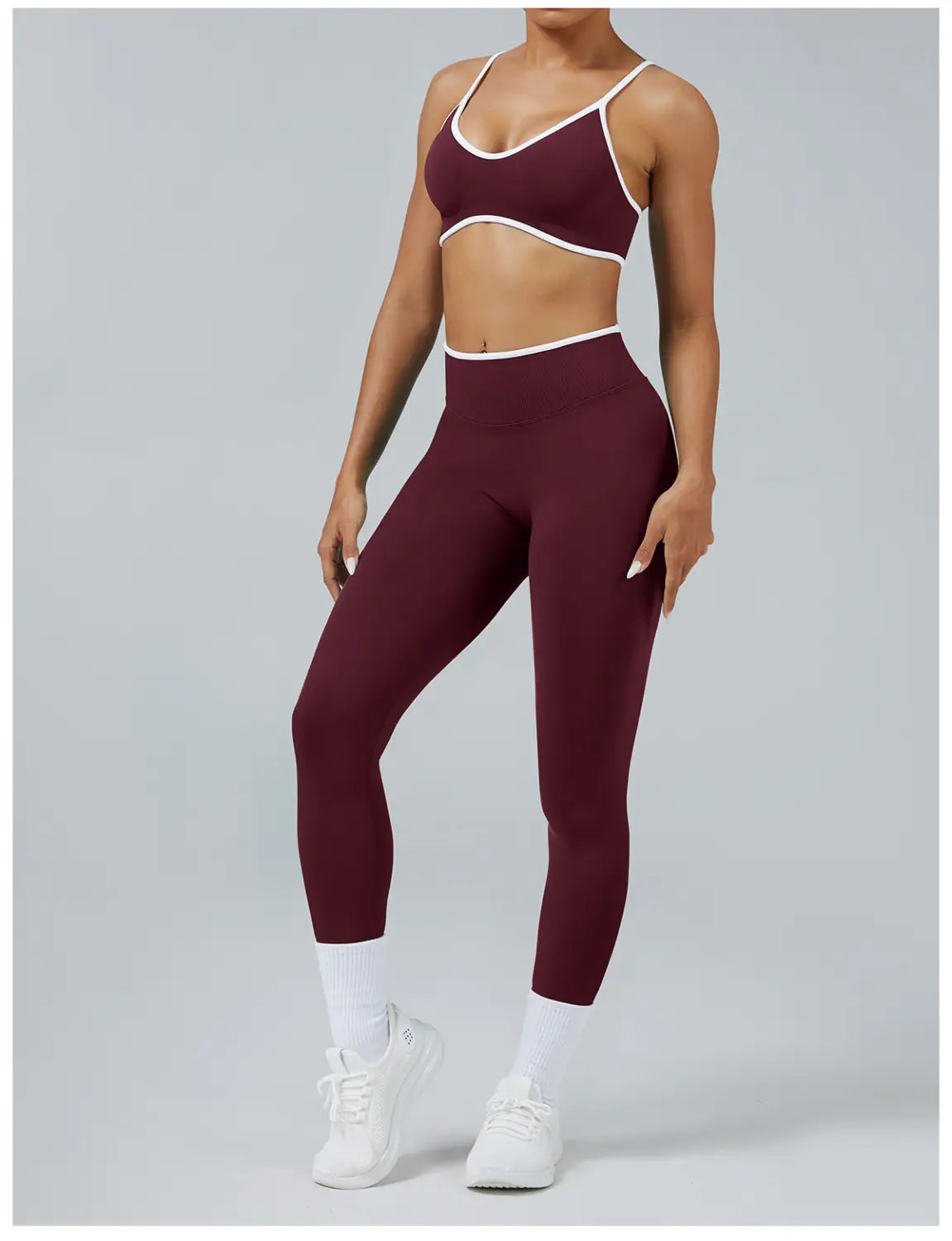 Maroon and white seamless high waist sports yoga leggings with a matching cropped sports bra featuring thin straps made of stretchy fabric.