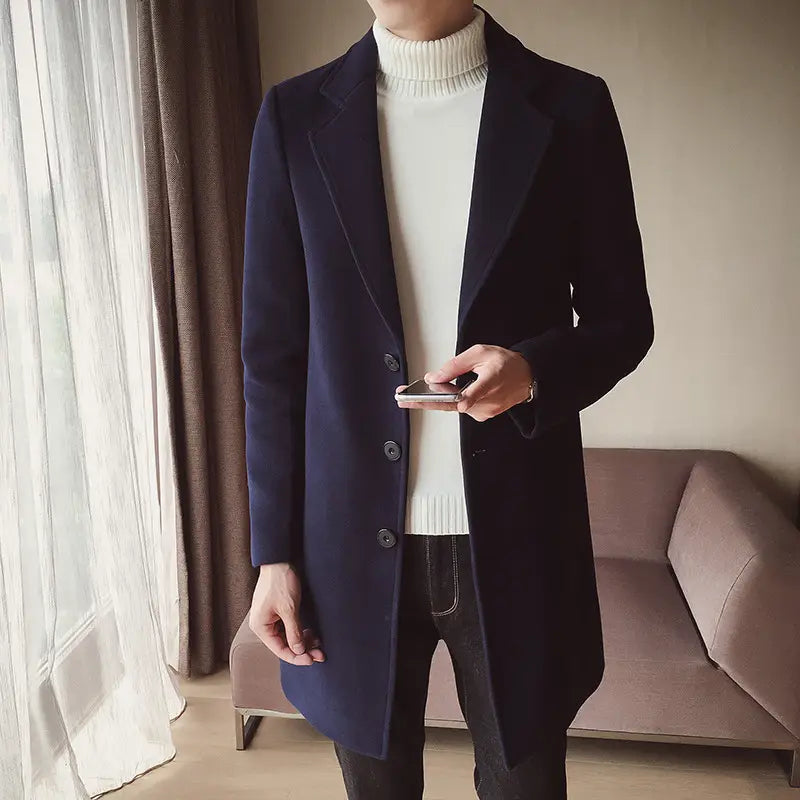 Navy blue wool mens slim trench coat in Korean style featuring notched lapels and three dark buttons.