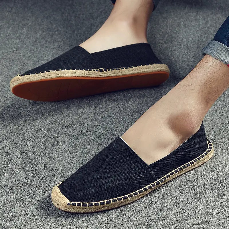 Men’s black canvas espadrille slip-on summer shoes featuring a woven jute sole and brown rubber outsole.