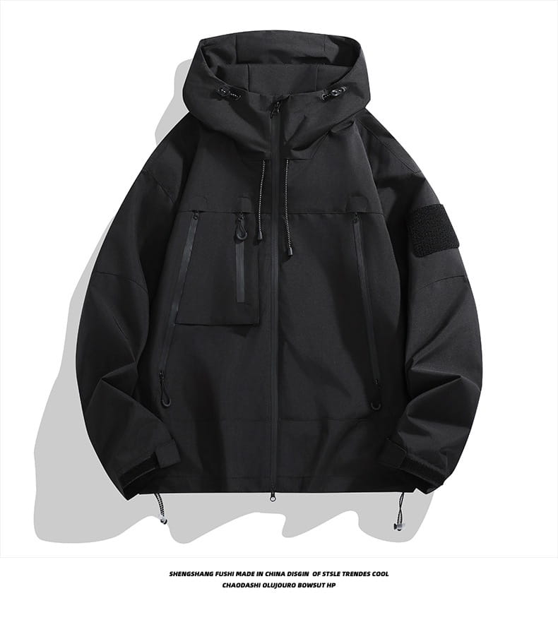 Schwarze taktische Kapuzen-Shelljacke mit Reißverschluss-Taschen, verstellbaren Kordelzügen und Ärmelpatch-Details.
