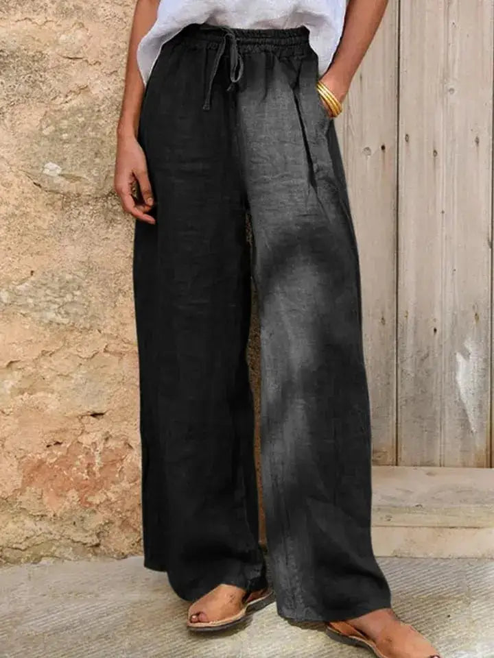 Black linen wide-leg pants with a drawstring waistband shown from the back.