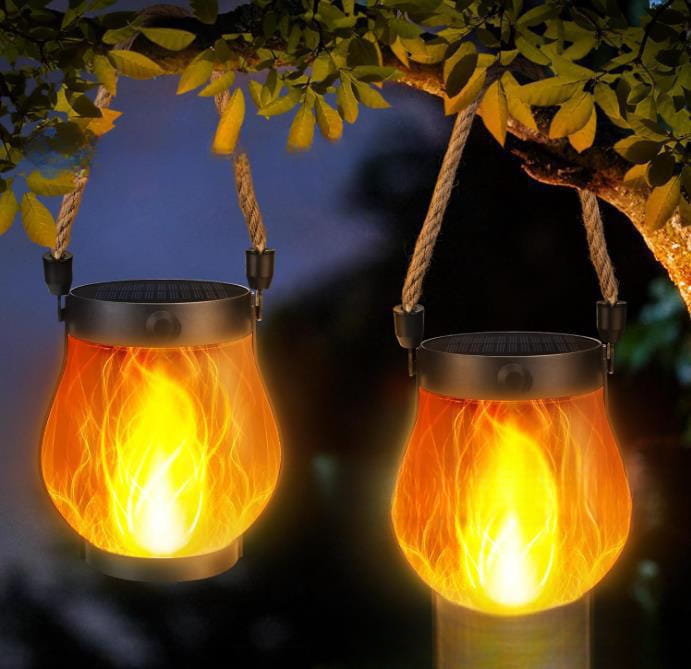 two hanging flickering flame garden lamp silver solar lanterns with glowing orange flame effects and black top and bottom rims