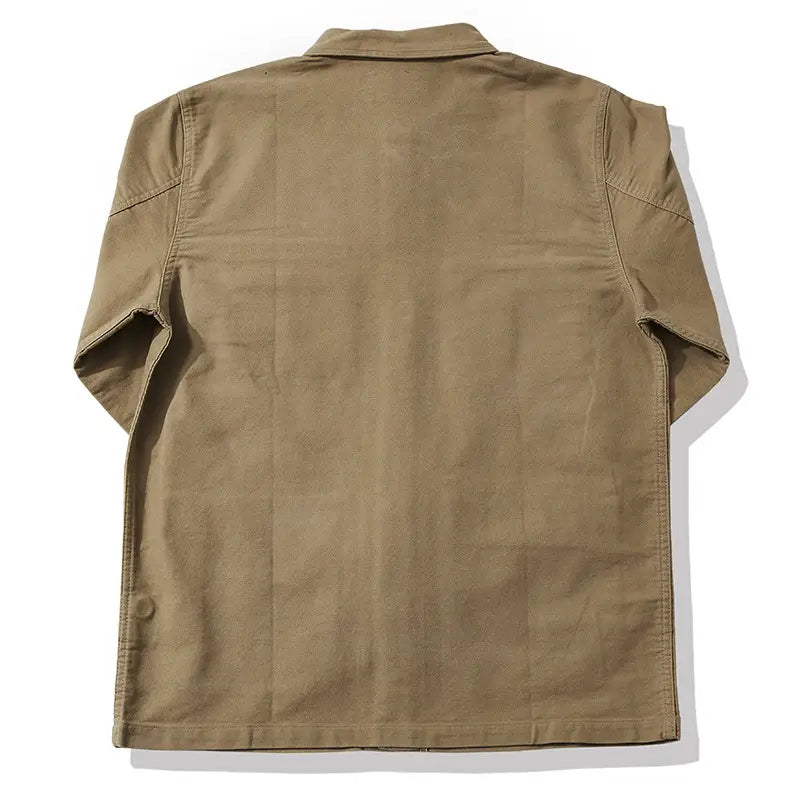 Khaki-colored mens french workwear jacket made of cotton with short sleeves, classic collar, utility pocket, and reinforced stitching for durability.