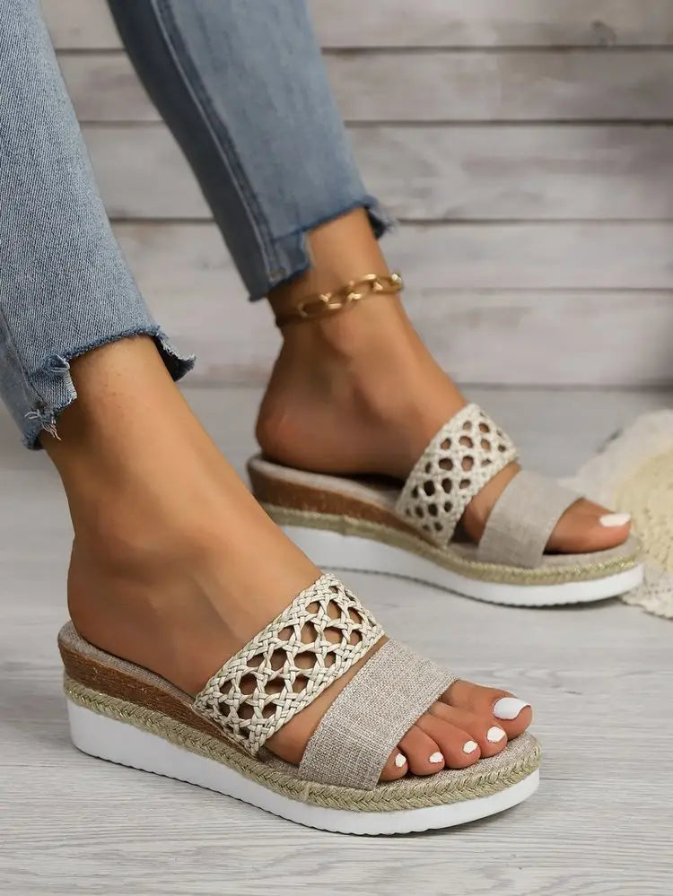 Beige woven espadrille platform wedge sandals for women featuring a textured fabric upper and an open-toe design.