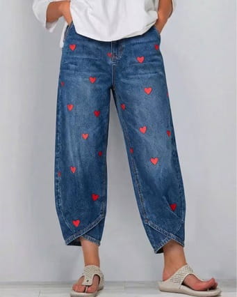 Blue denim pants for women featuring a red heart print pattern.