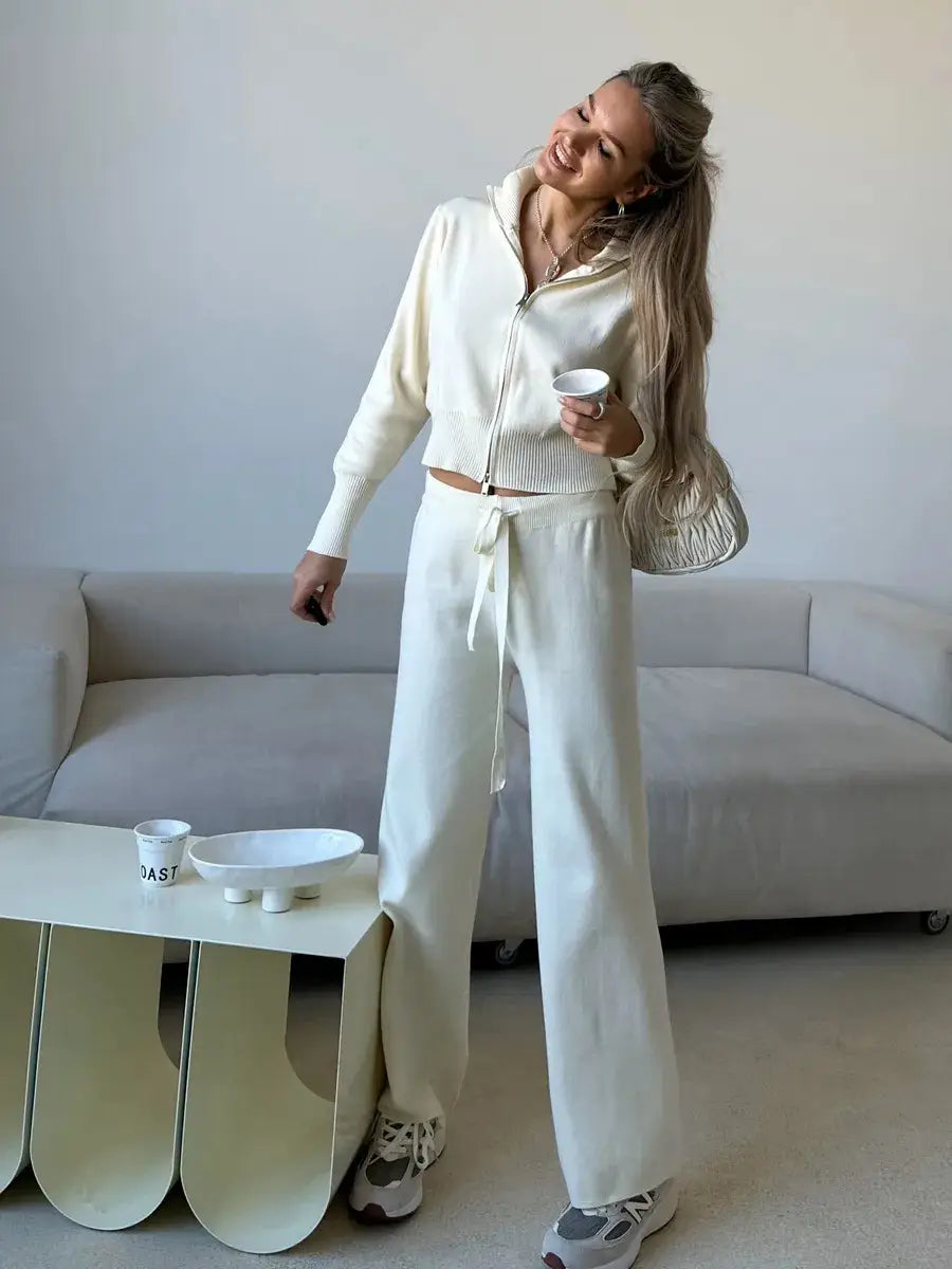 Cream-colored knit zip up cardigan and wide leg pant set featuring a matching drawstring pants and zip-up hoodie for women’s casual wear.