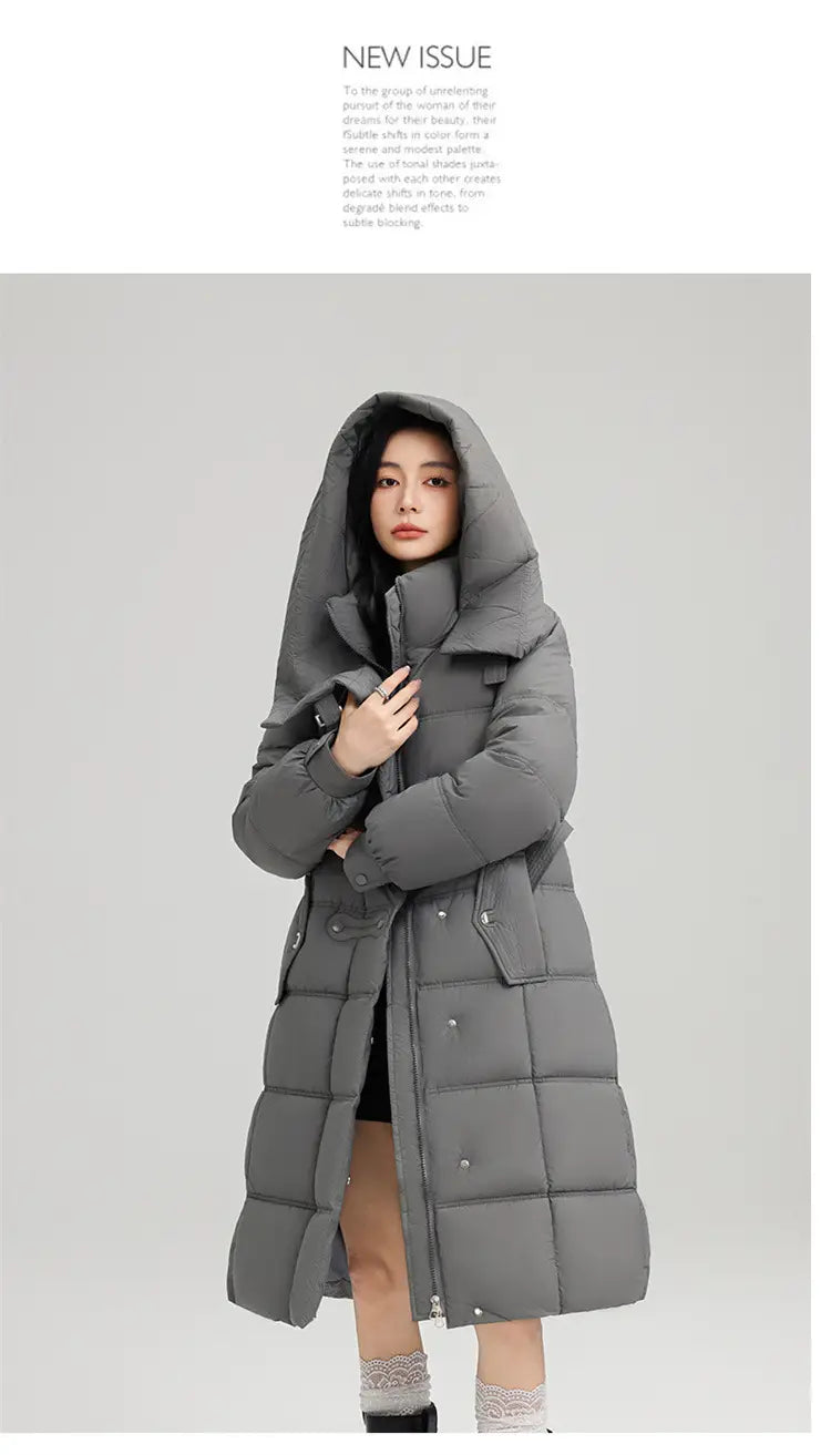 Ein langer grauer Slim-Fit-Steppmantel mit Daunenfutter für Damen mit Kapuze und vorderem Knopfverschluss.