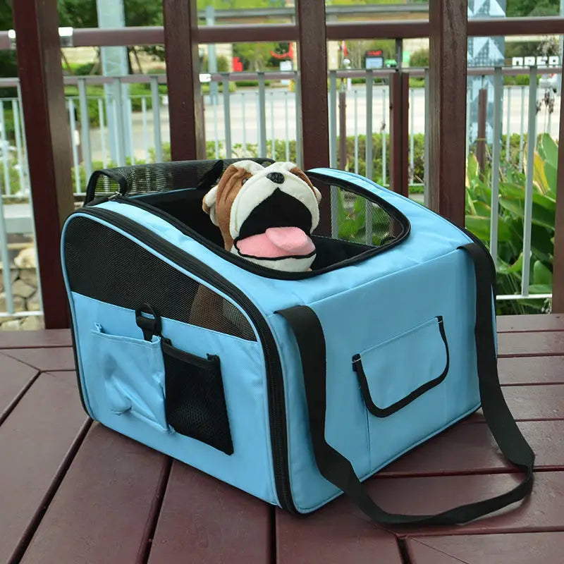 Light blue and black pet carrier backpack for small dogs and cats with mesh sides and a front pocket featuring a plush bulldog toy peeking out.