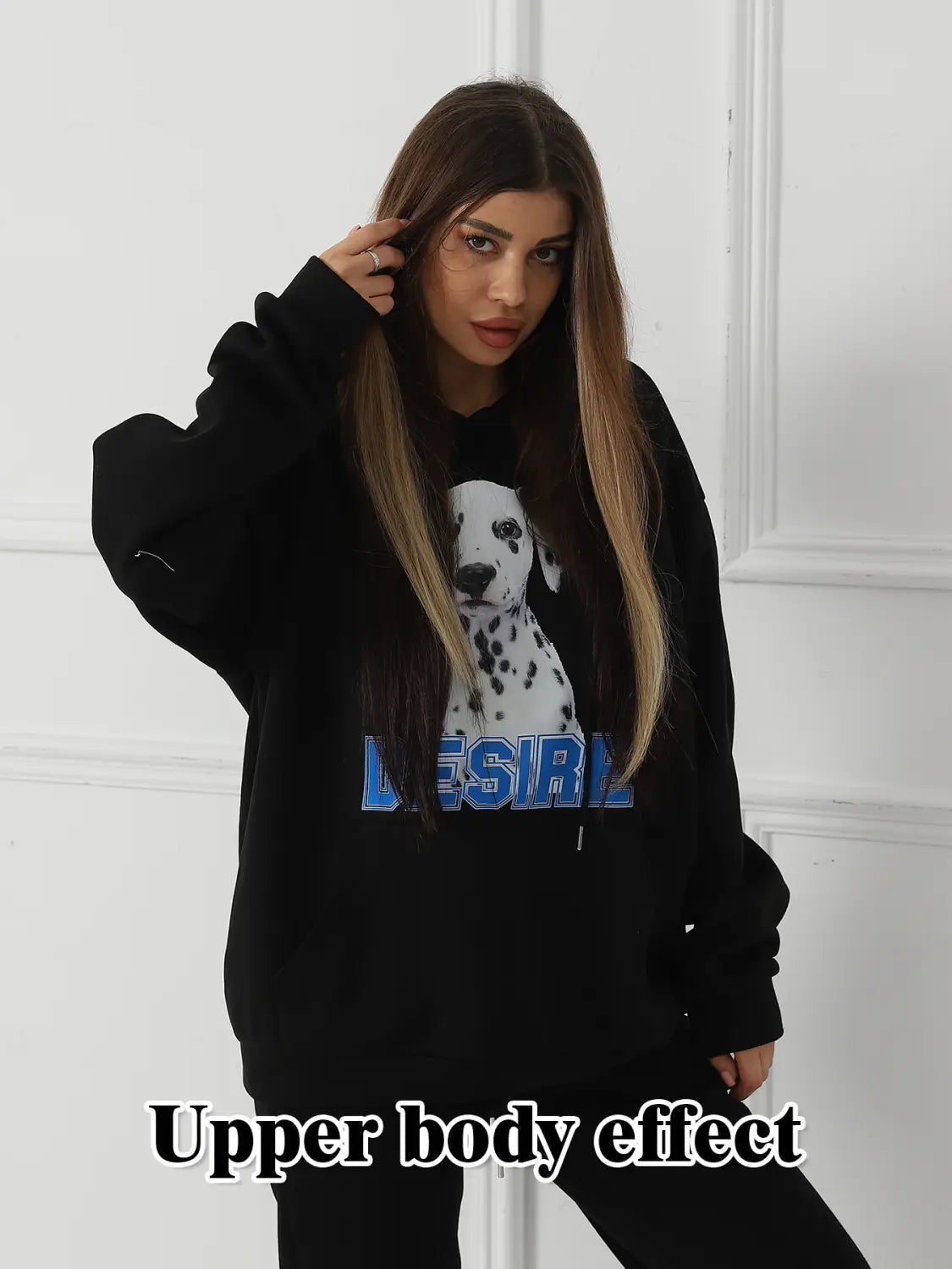 Black oversized women’s hoodie with white dalmatian dog graphic and blue lettering across the chest featuring a cat ear hood.