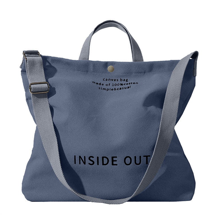 Tan canvas tote bag with high end large capacity black inside out lettering and wooden ring handles.