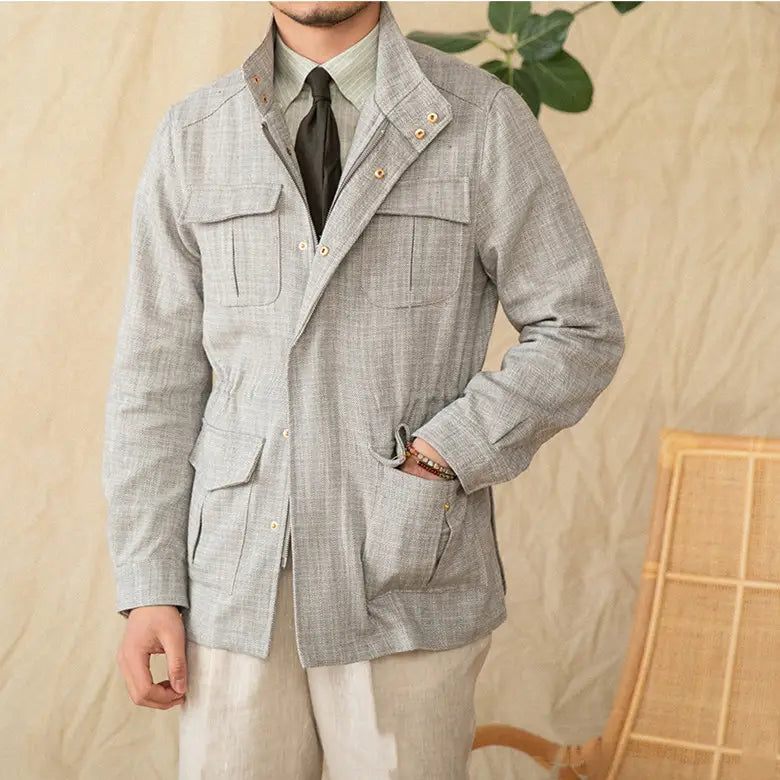 Light gray textured cotton linen m65 safari jacket with two chest pockets and flap closures.