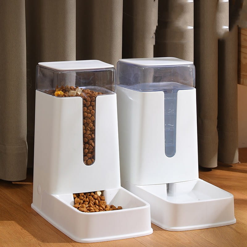 White plastic automatic pet feeder with transparent sides and clear lid designed for dispensing dry food in an automatic pet feeder and water dispenser.