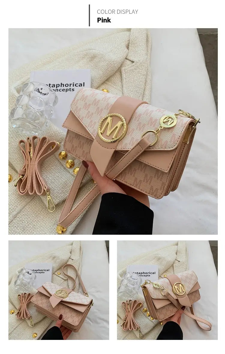 A blush pink monogram letter print crossbody messenger bag featuring a repeating pattern and gold-tone metallic logo hardware.