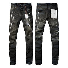 Men’s distressed slim fit black denim jeans with a worn-in rugged look and visible patches on the thighs.