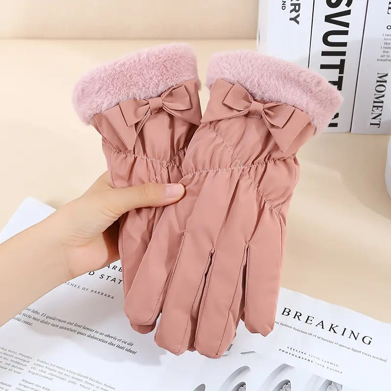 Pink quilted women touch screen winter fleece gloves shown from the back with fluffy pink faux fur cuffs and matching fabric bows.