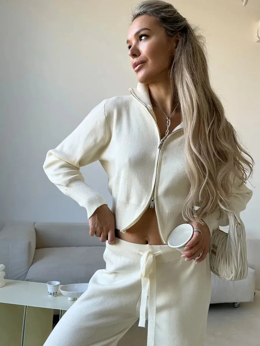 Cream-colored knit zip-up cardigan with ribbed cuffs and waistband from women’s knit zip up cardigan and wide leg pant set.