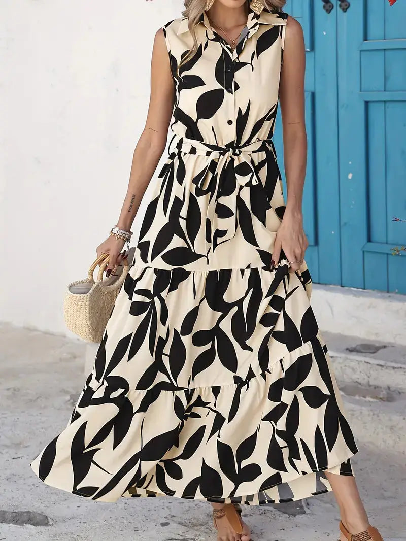Elegant leaf print sleeveless button front midi dress in cream and black with a tiered skirt perfect for formal occasions.