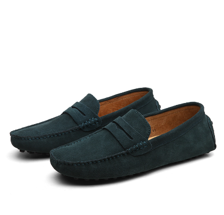 Mocassins en daim vert foncé avec un design classique de mocassin et une doublure en cuir camel comportant des surpiqûres contrastées.