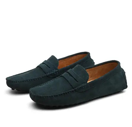 Dark green suede loafers with classic moccasin design and tan leather lining featuring contrast stitching.