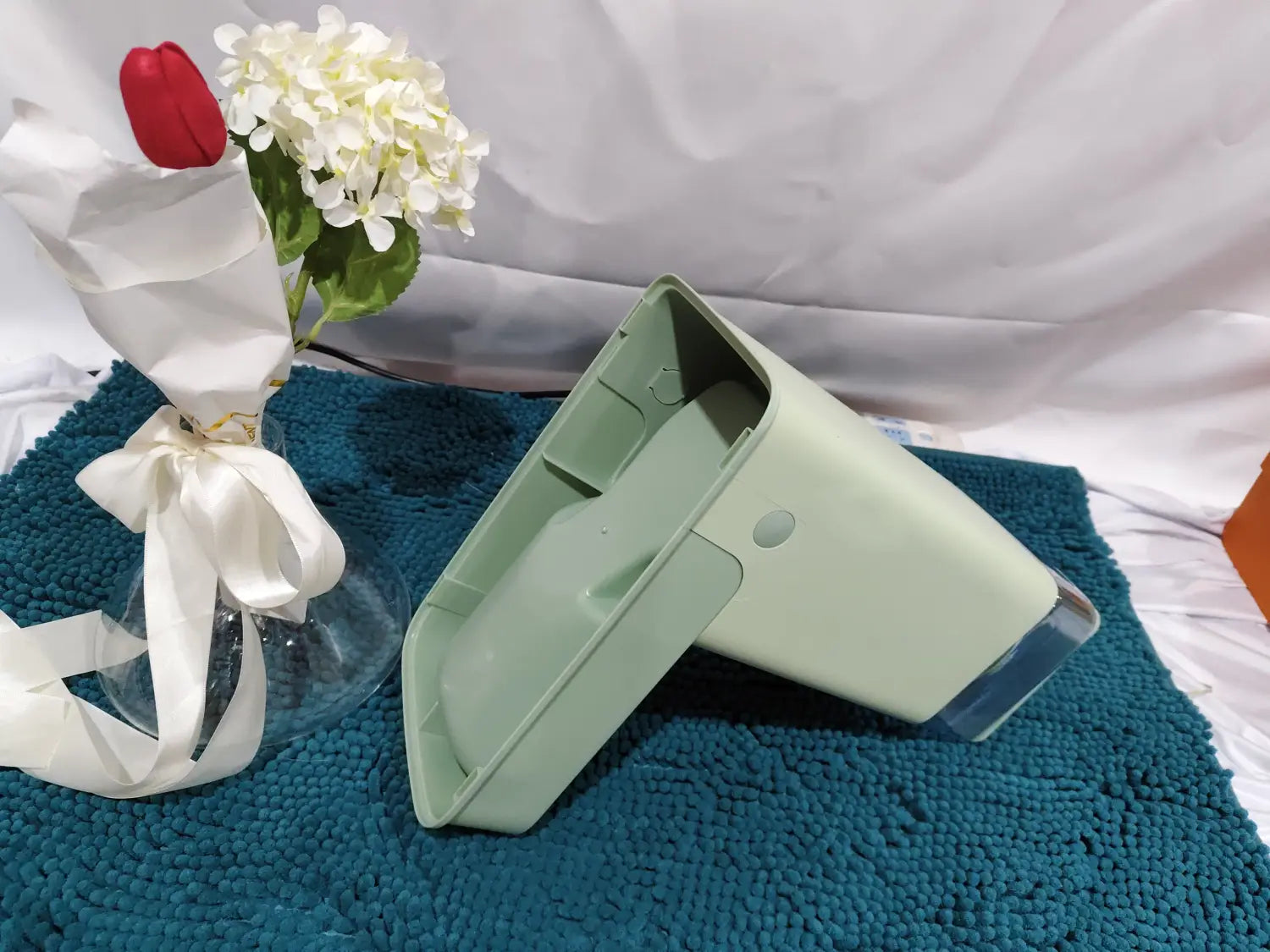 Light green plastic automatic pet feeder and water dispenser bowl with a clear lid and rounded edges.