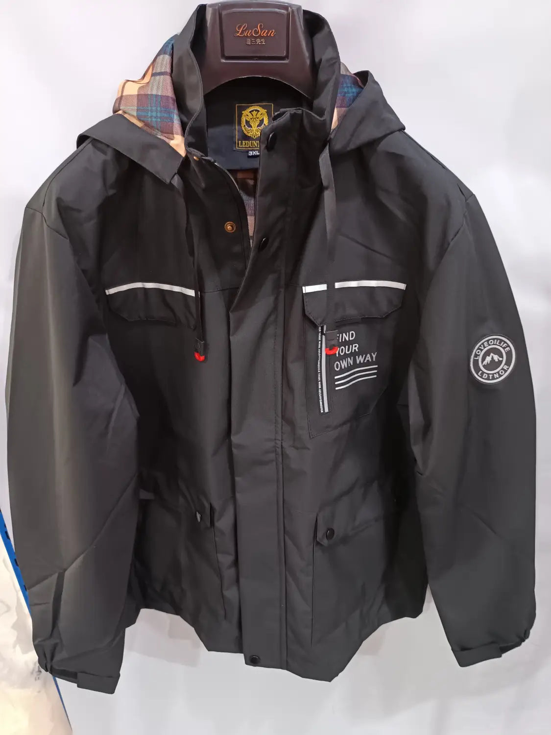 Men winter hooded parka coat by lasai in black featuring a waterproof material, white stripe accents, and a plaid inner lining.