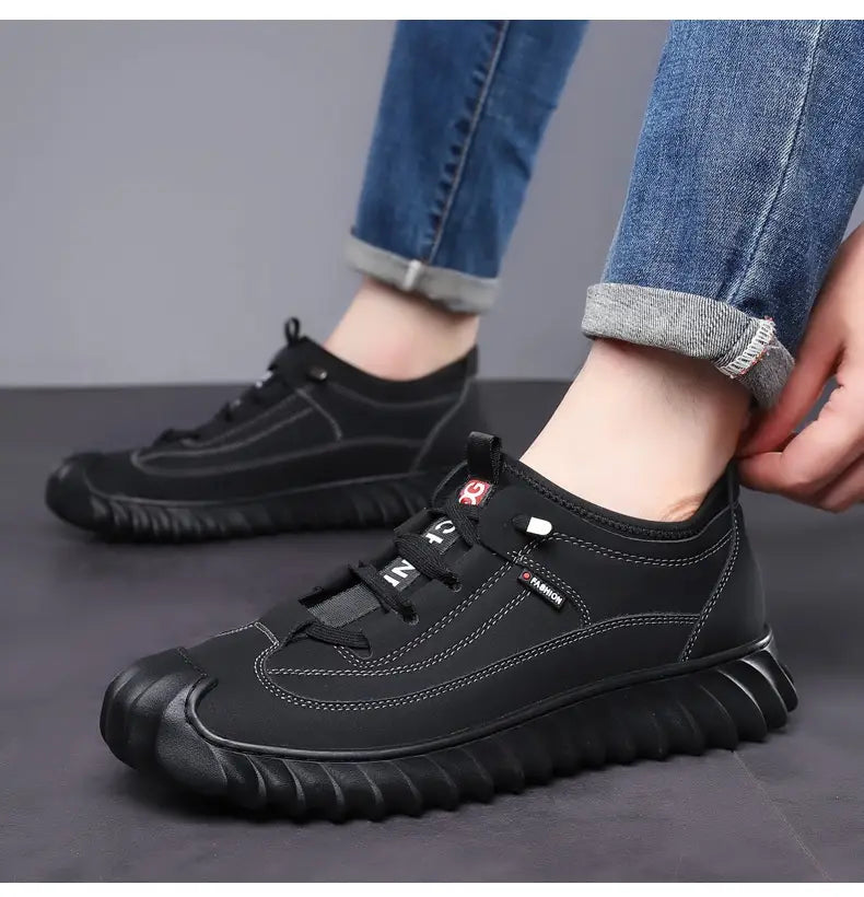 Men’s black leather lace-up casual sneakers with chunky rubber sole and subtle stitching details.