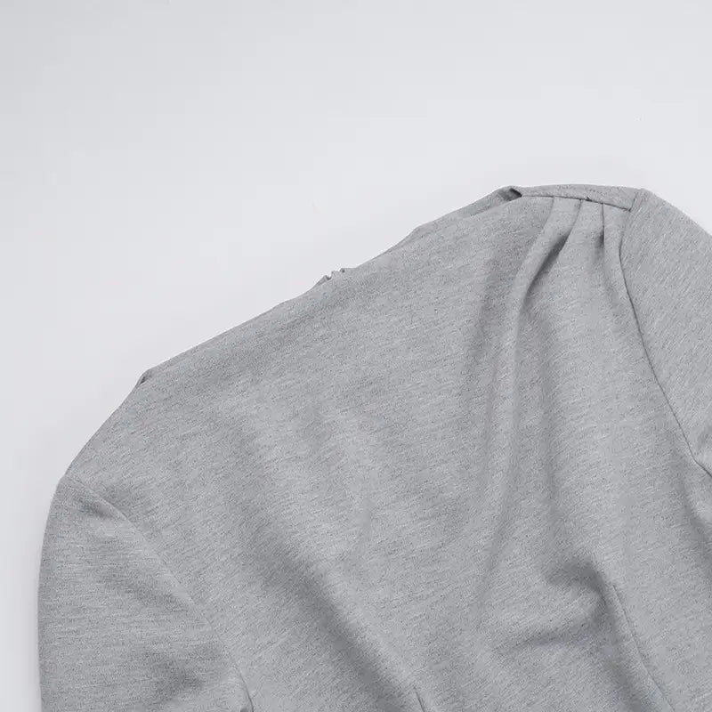 A soft heather gray slim fit long sleeve a line flared dress with subtle textured fabric and a rounded neckline.