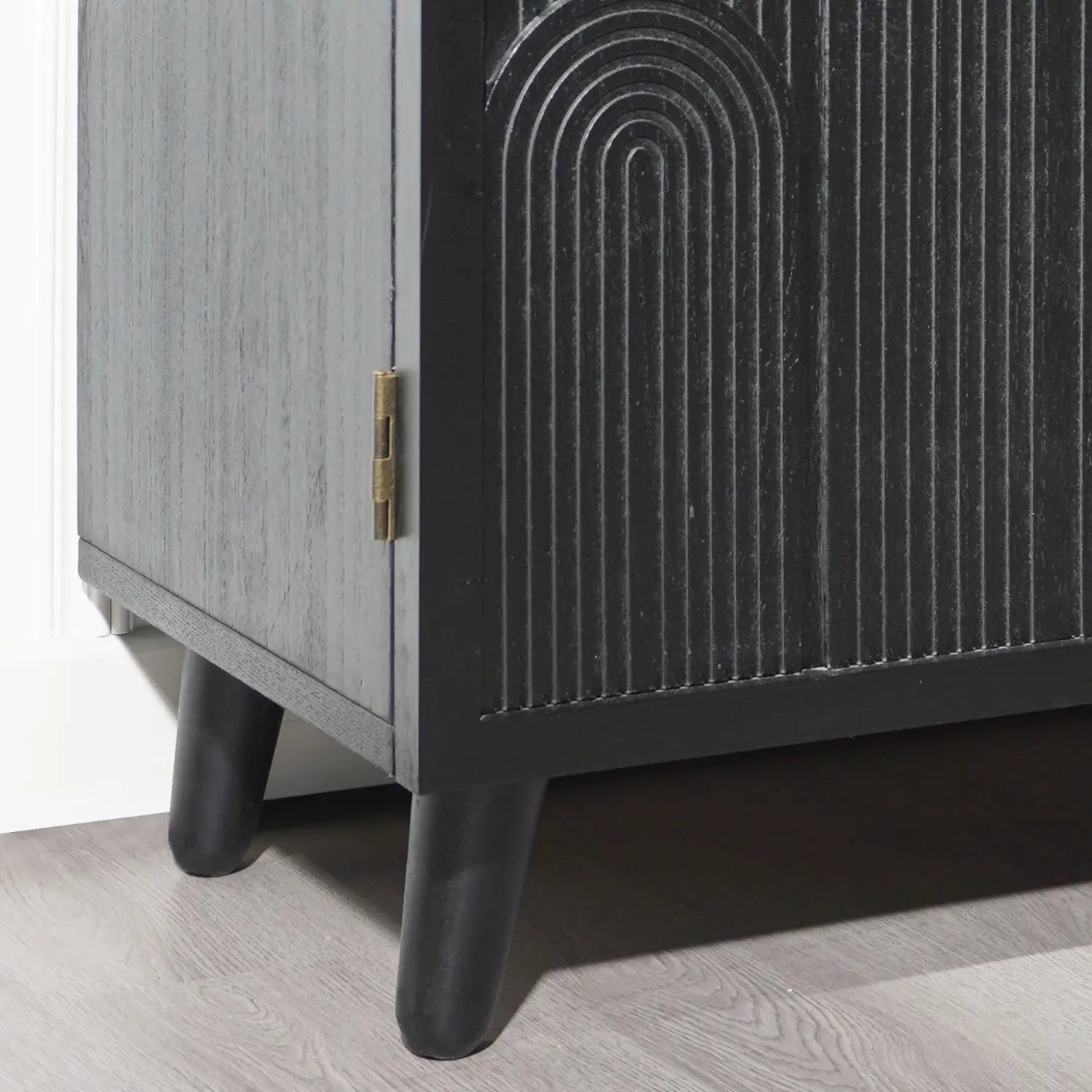 Black wood storage cabinet 31in arched accent cabinet featuring black and gray mid-century modern design with carved arched patterns on the door, brass hinges, and tapered legs.