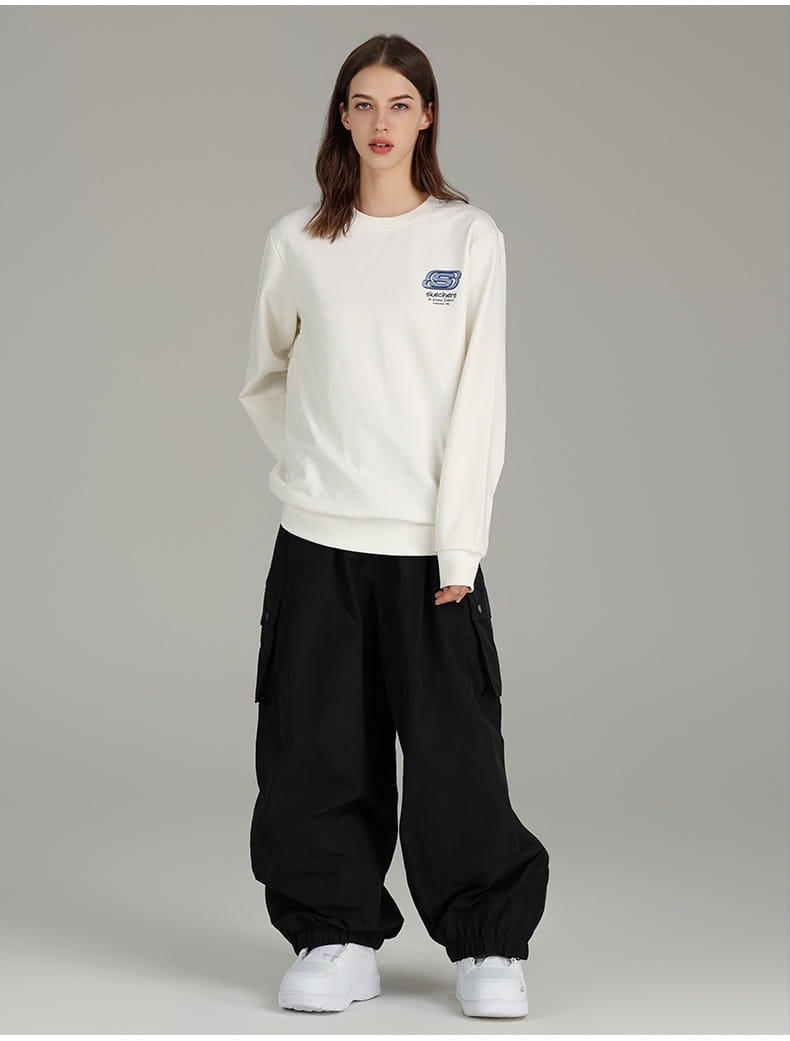 White long-sleeved sweatshirt featuring a small blue and black logo on the left chest paired with winter outdoor loose ski pants.