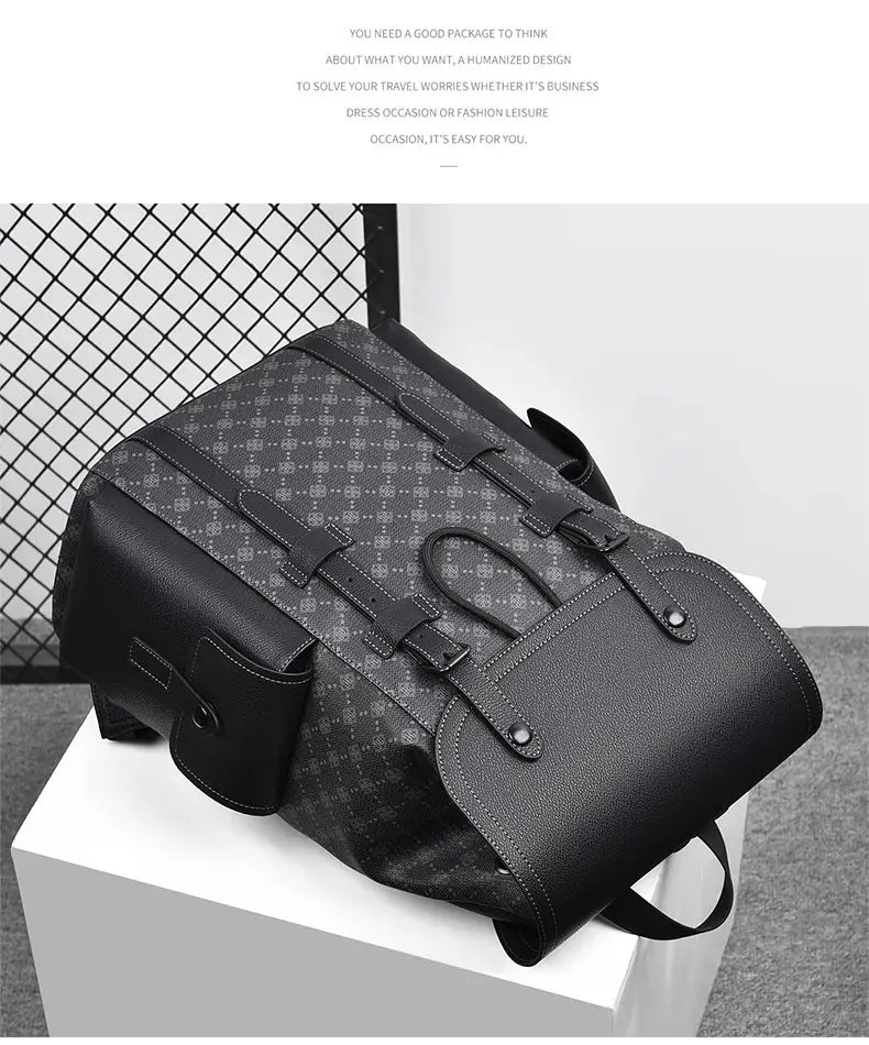 Men’s leather business travel backpack in black and gray pattern with leather-like straps and textured front flap featuring a laptop sleeve.