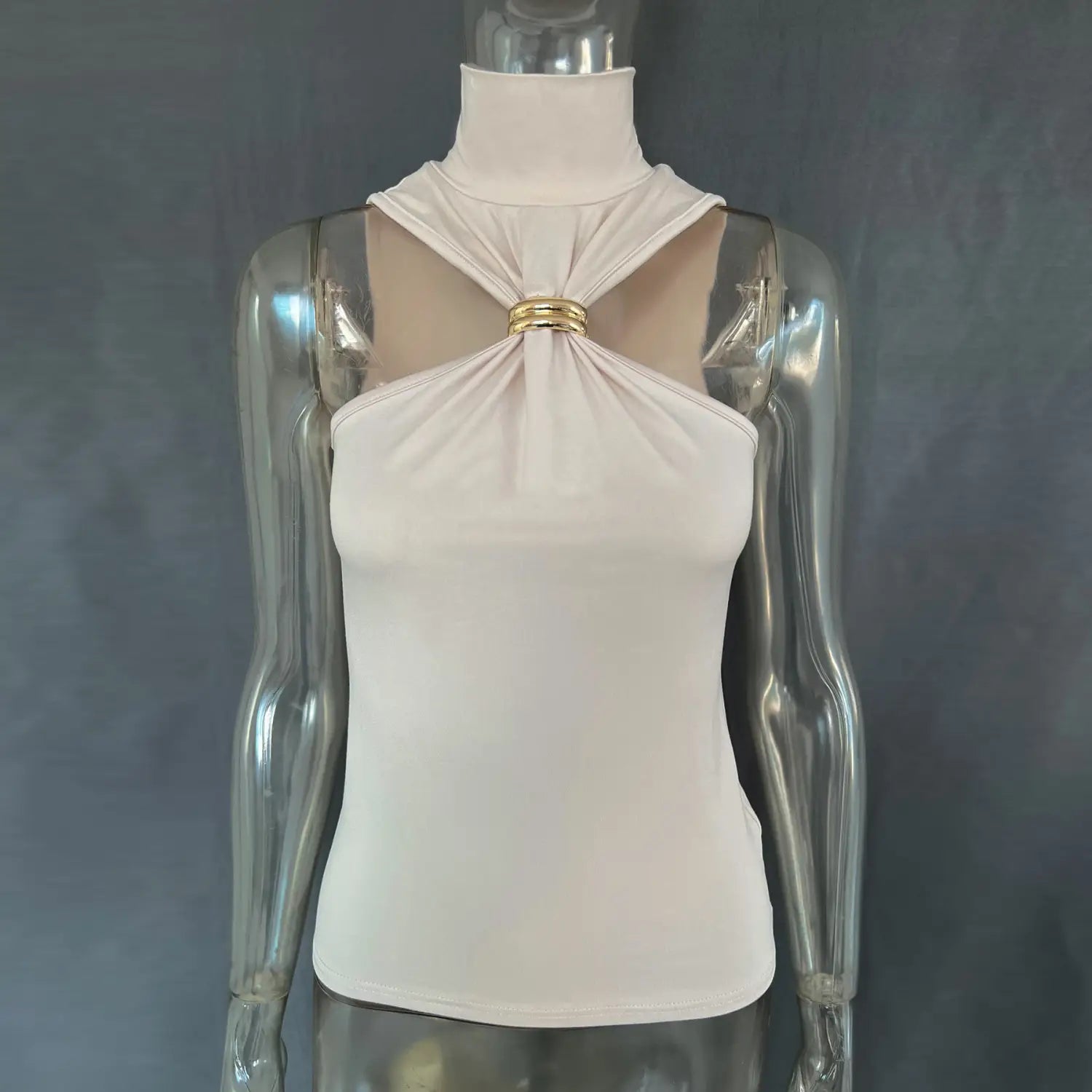 A sleek off-white halter stretch top featuring a distinctive gold-toned metallic clasp at the neckline.