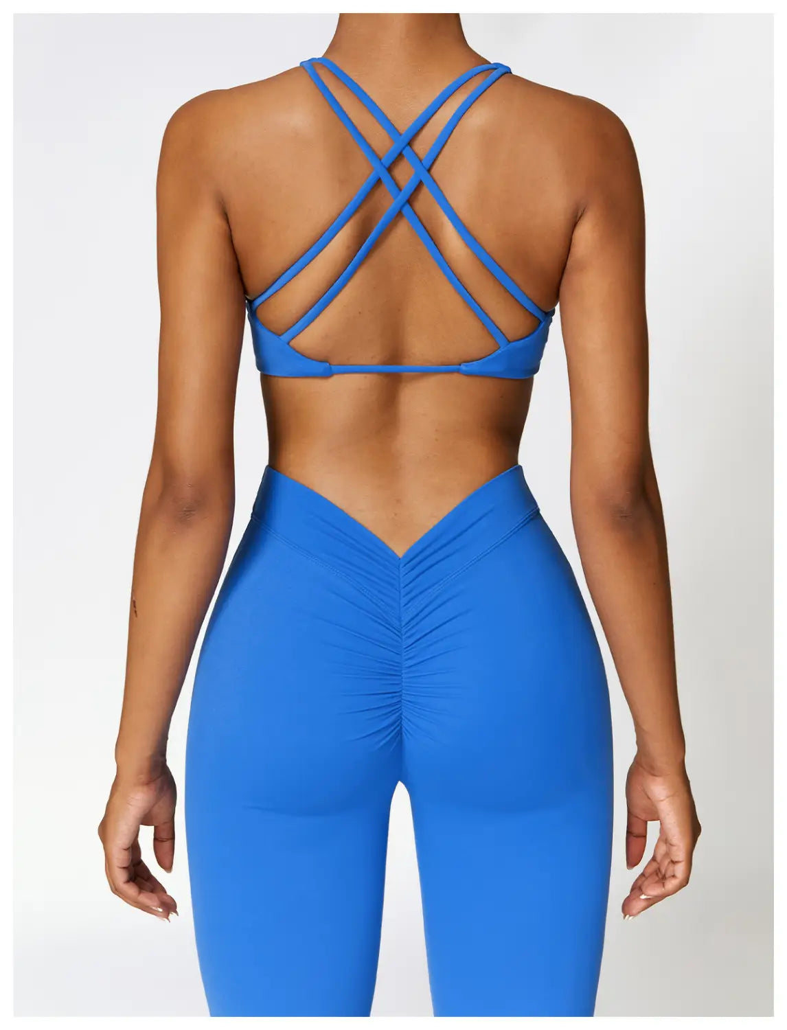 blue crisscross back sports bra paired with high-waisted flared yoga pants active trousers designed for comfortable exercise and movement.