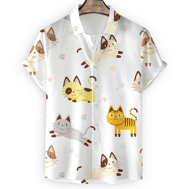 Camisa blanca de manga corta y de corte ajustado, tipo botonadura, con un patrón juguetón de gatos de caricatura coloridos; diseñada como camisa hawaiana para hombre con estampado floral.