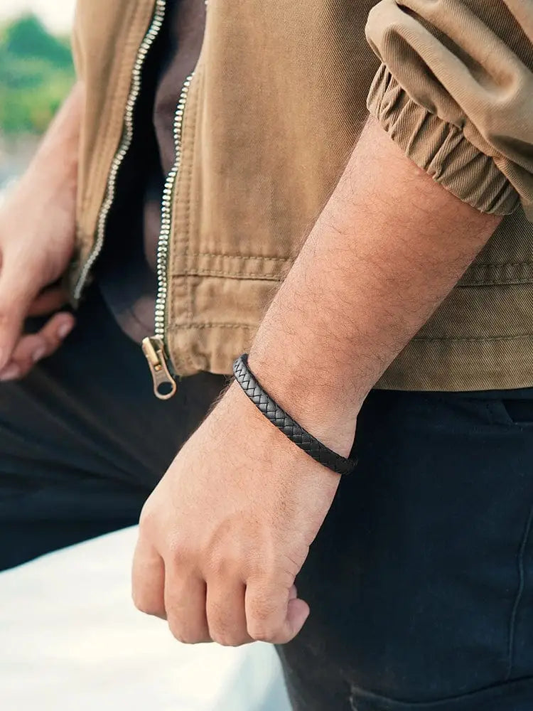 A 7mm black braided leather bracelet with stainless steel clasp worn on a wrist showcasing its design and fit