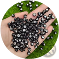 Black acrylic alphabet and number beads featuring smooth plastic finish white uppercase letters in uniform round shapes