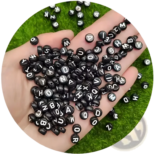 Black acrylic alphabet and number beads featuring smooth plastic finish white uppercase letters in uniform round shapes