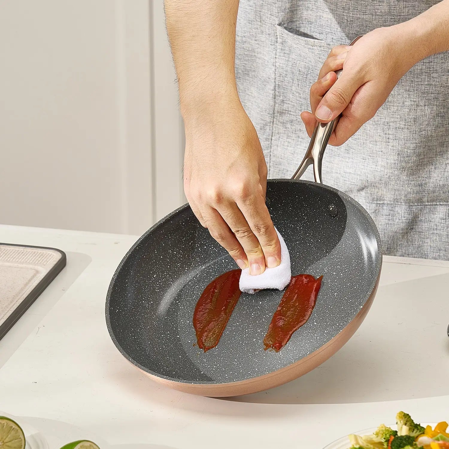 Rose gold nonstick frying pan with speckled black ceramic interior and stainless steel handle from a 3-piece nonstick ceramic frying pan set with handles.