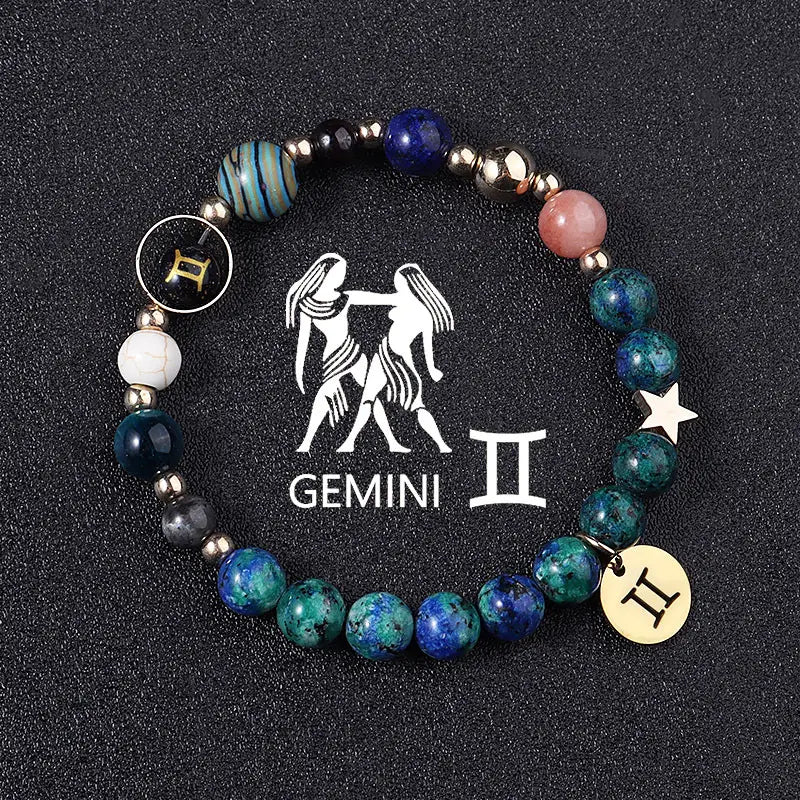 Natural stone zodiac constellation beaded bracelet featuring a Gemini theme with blue green and pink stones metallic accents and charms.