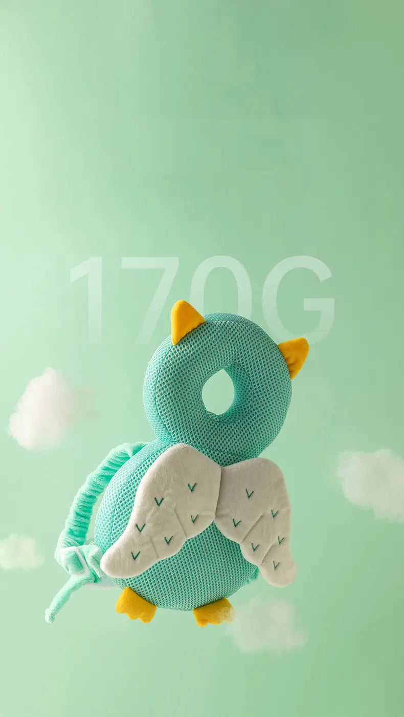 A soft teal knitted owl baby head protector anti fall plush backpack cushion with yellow felt horns, green embroidered wings, and matching feet.