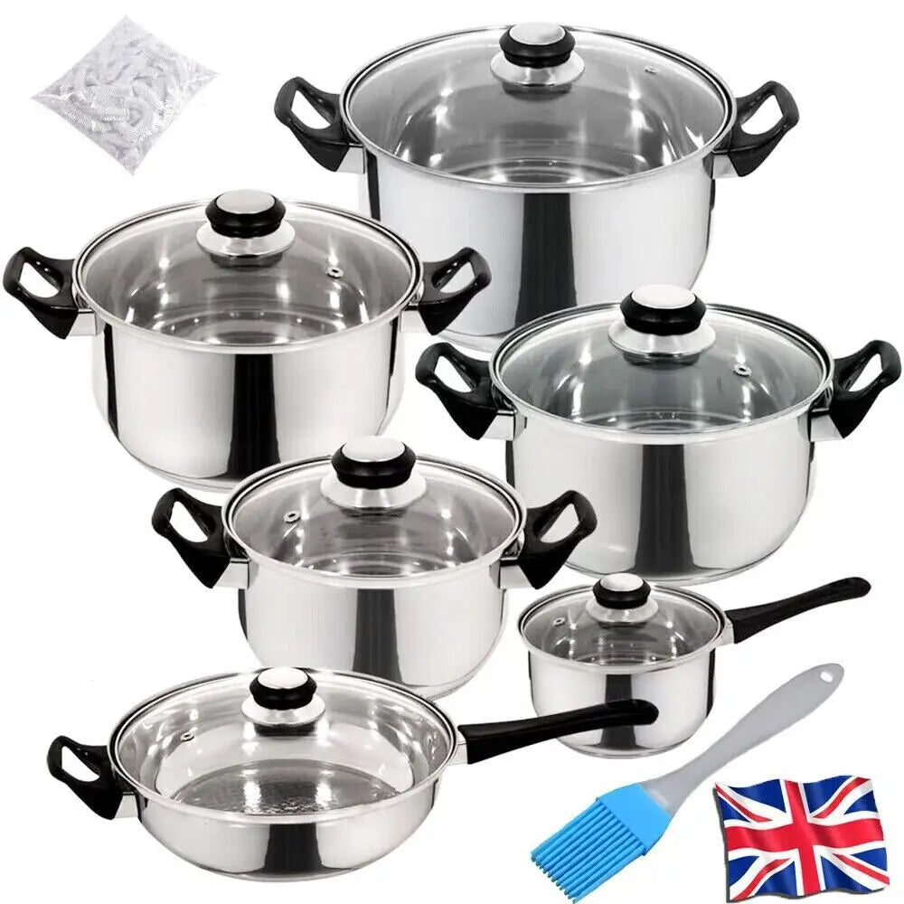 Set of stainless steel cookware pots and pans with black handles, glass lids, and white knobs in a 12 piece cookware set.