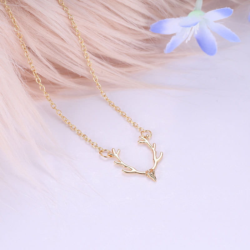 Gold antler gemstone pendant clavicle necklace featuring a gold-toned deer antler design with a small gemstone at the tip.