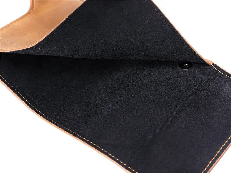Black suede-lined crazy horse leather metal card case wallet with tan leather edges and contrasting stitching.