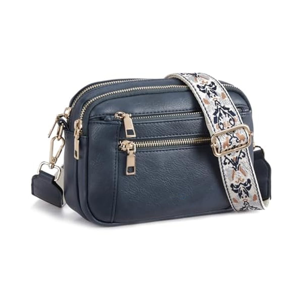 Navy blue faux leather crossbody bag featuring triple gold-tone zippers and an ornate floral colorblock strap.