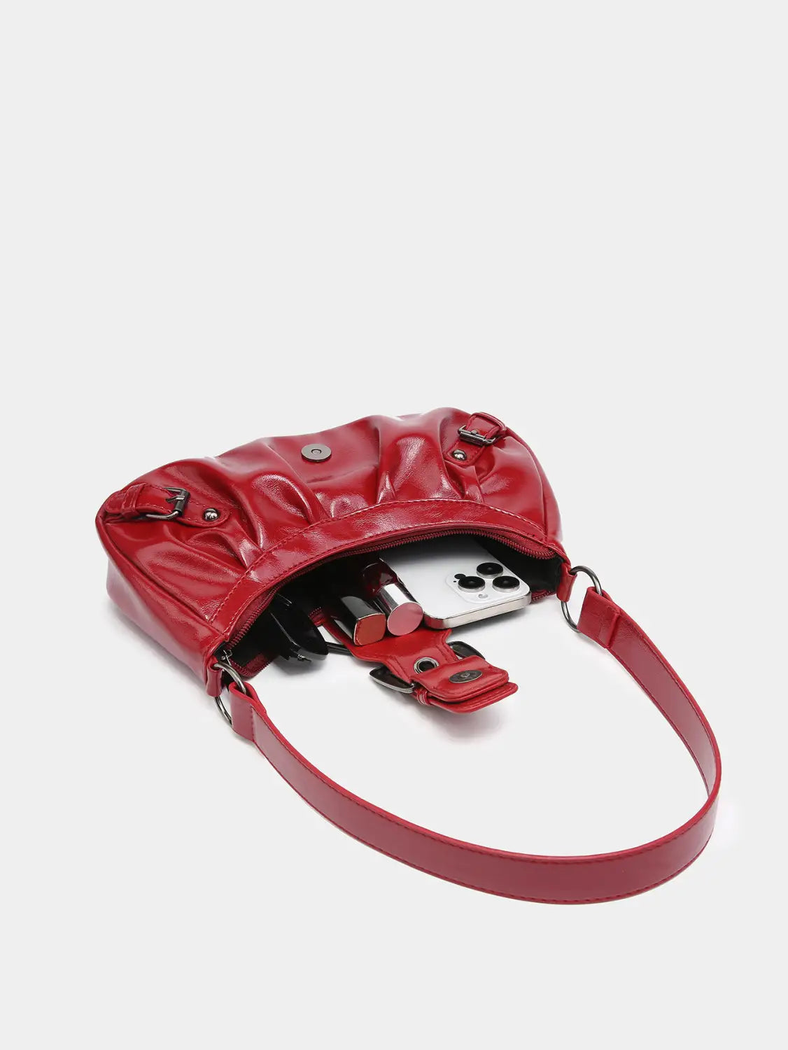 Vintage leather shoulder bag in glossy red faux leather with quilted design and adjustable crossbody strap featuring buckle details.