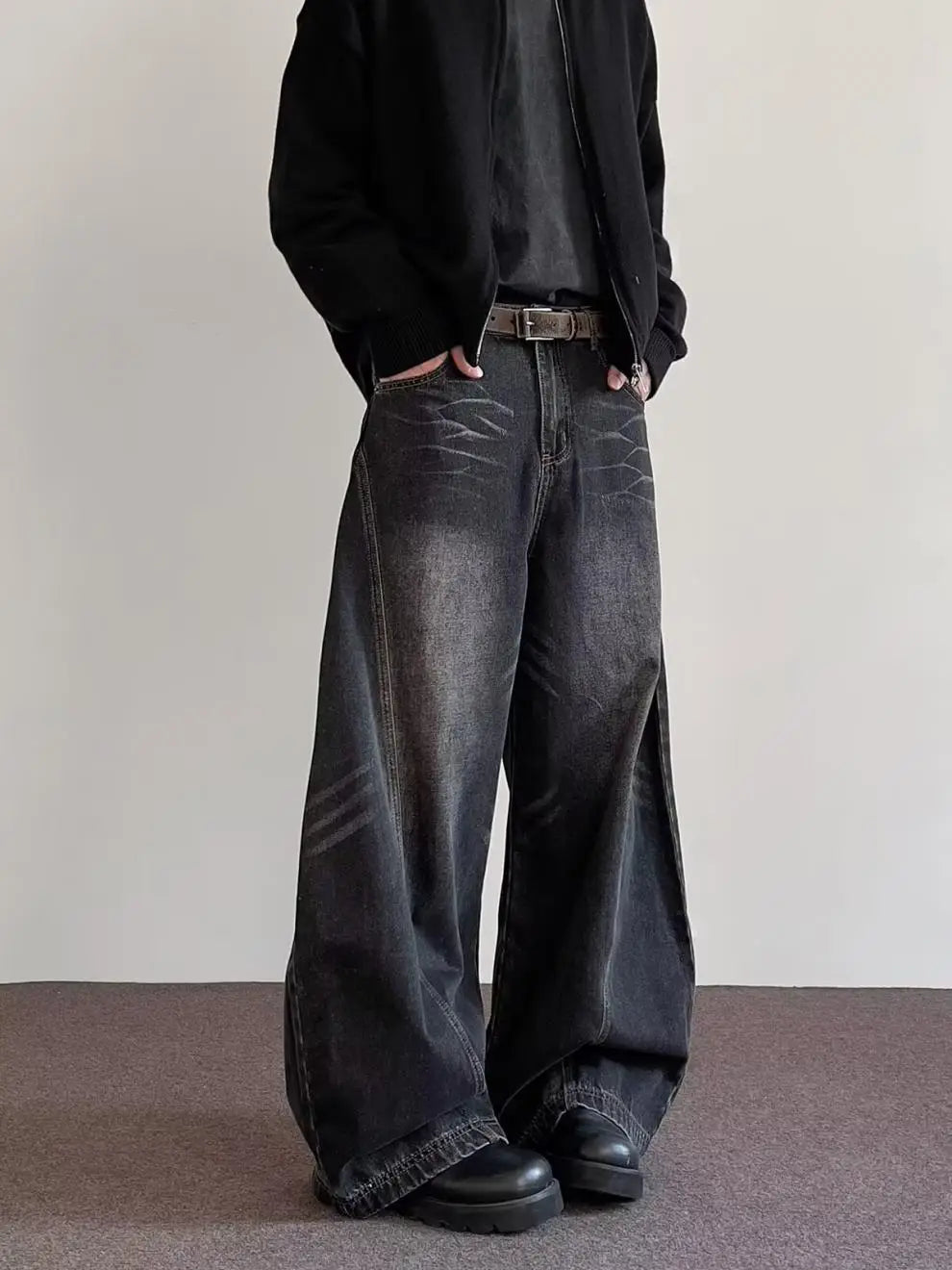 Men’s premium relaxed wide leg denim jeans in black with a faded distressed texture and subtle whiskering details.