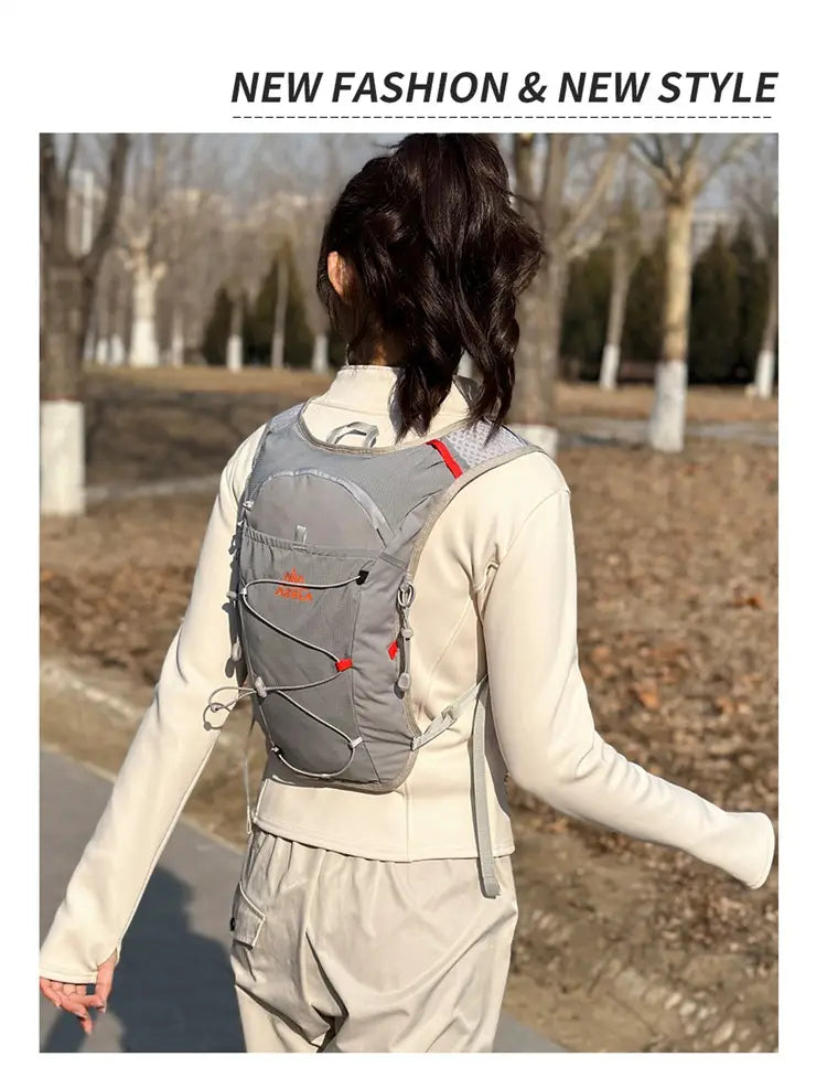Gray and red hydration backpack lightweight running vest 20l with mesh panels and adjustable straps shown from the back side.
