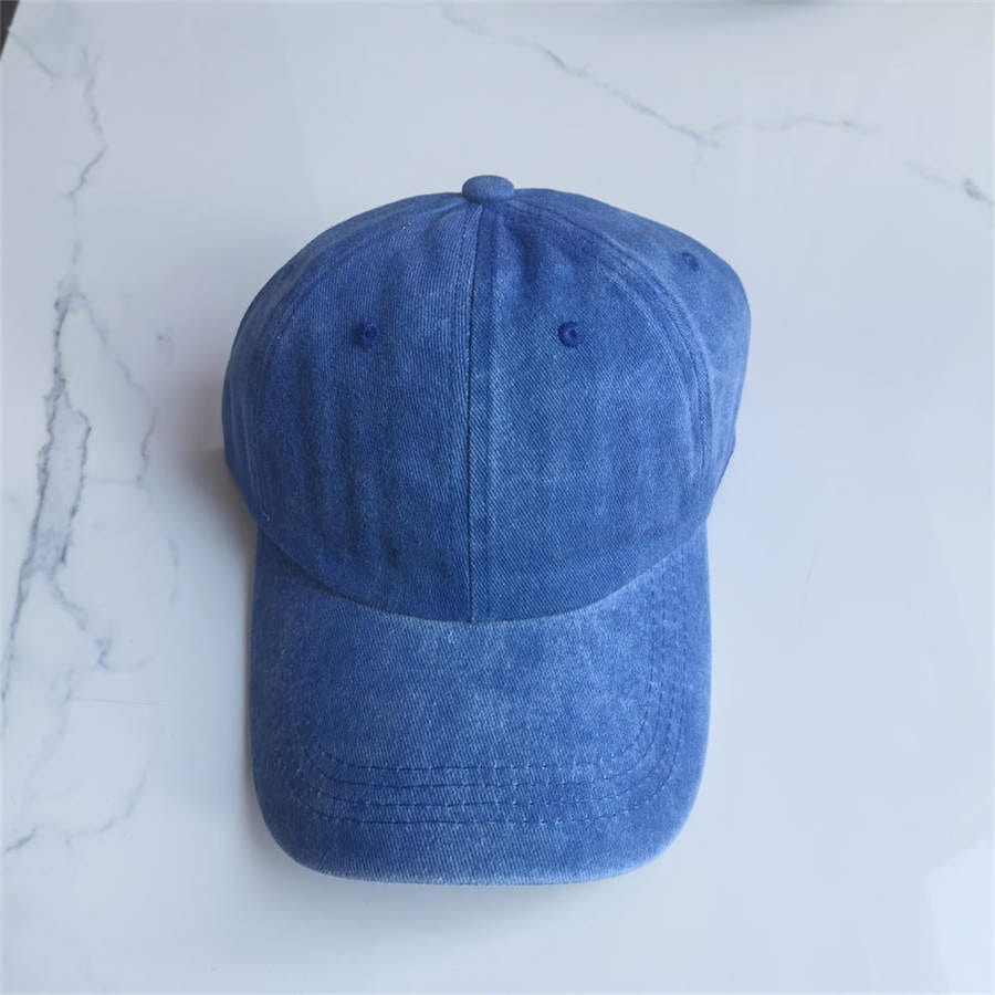 A classic blue denim cotton baseball cap with a vintage washed sun hat finish and visible stitching details.