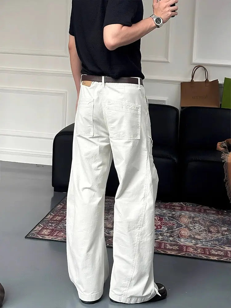 White wide-leg cargo pants in cotton fabric featuring multiple pockets and a relaxed fit for casual wear.